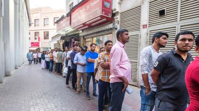 People queue to get take away porridge for iftar at Lootah Mosque.