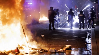Police officers intervene during the second night of riots after a deadly accident involving a minor on a scooter in Lausanne, Switzerland. EPA