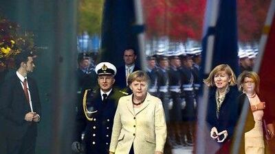The German chancellor Angela Merkel, centre, opposed the $70 billion merger between BAE Systems and EADS. John Macdougall / AFP