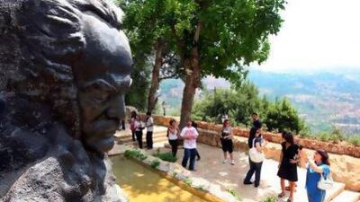 A statue of the Lebanese poet and artist Gibran Khalil Gibran, who was born 130 years ago this month, stands outside his house in Bsharri. Joseph Barrk / AFP