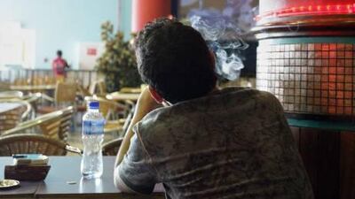 A teenager smokes at the Food Court in Marina Mall. The World Health Organization study also found that 82 per cent of teenagers have tried smoking by their fourteenth birthday.