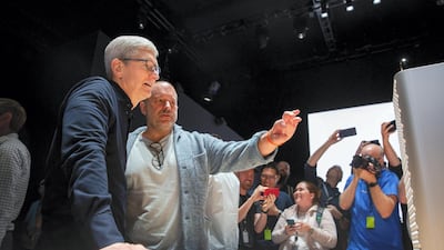 Apple CEO Tim Cook and Apple's Chief Design Officer Jonathan Ive look over the new Mac Pro computer. AFP