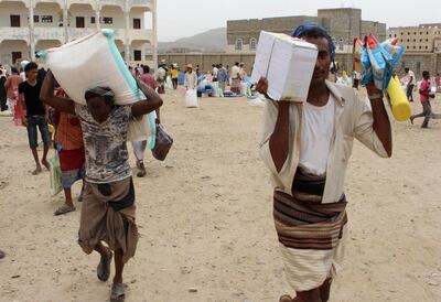 Displaced Yemenis from Hodeida receive humanitarian aid. AFP