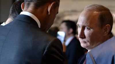 Barack Obama speaks to Russian president Vladimir Putin before the Apec summit plenary session in Beijing this week. (Alexy Druzhinin / AFP)