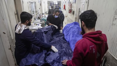 Paramedics with body bags at a hospital during fighting between government forces and the Kurdish-led Syrian Democratic Forces in the northern Syrian city of Aleppo on December 22. Reuters