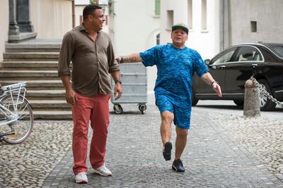 Former Brazilian soccer star Ronaldo, left, and former Argentinian soccer star Diego Maradona, right, share a joke as they arrive for the Gianni's game, a soccer match with football legends, in Brig, Switzerland, Friday, July 7, 2017. (Jean-Christophe Bott/Keystone via AP)