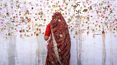 A woman performs rituals for the well being of her family during the Sheetla Saptami Hindu festival in Ajmer. AFP