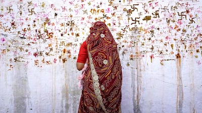 A woman performs rituals for the well being of her family during the Sheetla Saptami Hindu festival in Ajmer. AFP