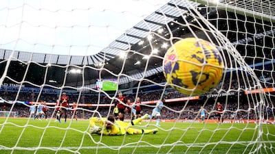 Jeremy Doku finishes past Bournemouth keeper Ionut Andrei Radu to put City 1-0 up. Getty Images