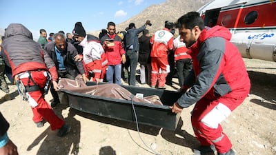 Members of the Iranian Red Crescent carry a body recovered from a wreckage of the private jet in the mountains around the city of Shahr-e Kord, Iran. Morteza Salehi / EPA