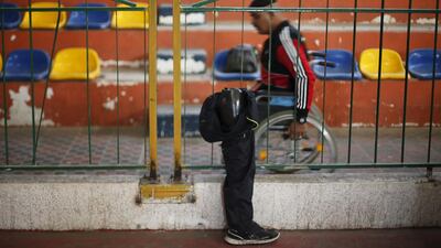 A disabled Palestinian passes by an artificial limb before the start of a local wheelchair basketball championship in Gaza City. Suhaib Salem / Reuters TPX IMAGES OF THE DAY