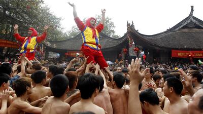 Villagers perform a ritual during the traditional firecracker festival in Dong Ky, Bac Ninh province, Vietnam, on February 3, 2014. The festival which is held on the fourth day of the first lunar month every year, has attracted thousand of people. Luong Thai Linh / Reuters