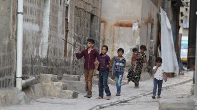 Yemeni children walk through an alleyway in the old city of Sanaa. EPA