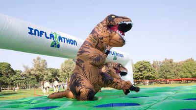 Two T-Rex's race through the obstacle course durin gthe inflatable heat. Leslie Pableo for The National