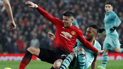Manchester United's Marcos Rojo in action with Arsenal's Pierre-Emerick Aubameyang. Reuters