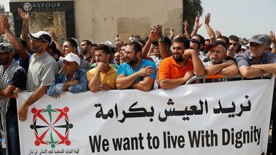 Palestinian refugees hold a banner as hundreds of refugees request asylum at a rally outside the the Canadian Embassy, in Beirut, Lebanon. AP