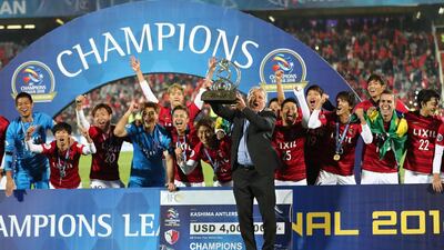 Former Kashima Antlers player and manager Zico and Kashima Antlers players celebrate with the Asian Champions League trophy. Getty Images