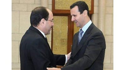 A handout picture released by the official Syrian Arab News Agency (SANA) shows Syria's President Bashar Al Assad (R) welcoming Iraqi Prime Minister Nouri Al Maliki at Al Shaab presidential palace in Damascus in 2009.