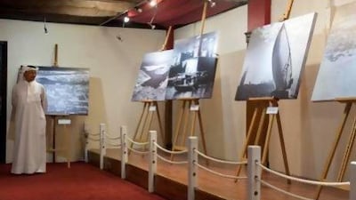 The two-week exhibition showcases sepia-tinted photographs of an age when pearl divers and fishermen depended on the sea for their survival. Razan Alzayani / The National
