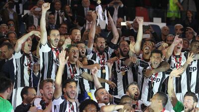 Juventus defender Giorgio Chiellini, centre, lifts the Coppa Italia. Paolo Bruno / Getty Images
