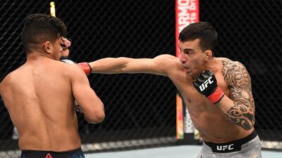 Thomas Almeida punches Jonathan Martinez during their bout in Abu Dhabi. Getty