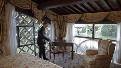 Maurizio Tagliavia sets the room for guests at Villa Del Quar. Max Rossi / Reuters