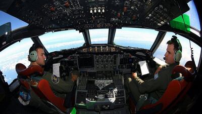 Flight Lieutenants Russell Adams (L) and Joal McCutcheon sit in the cockpit of a Royal Australian Air Force. Australia has been a key player in the search for the missing Malaysian Airlines jet. Paul Kane / Reuters March 26