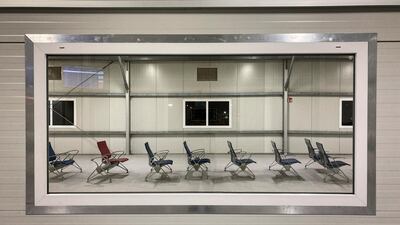 Empty seats at a boarding gate, seen through a window, at the airport in Nairobi, Kenya, December 23, 2020. AP