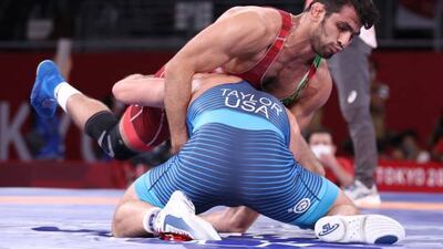 USA's David Taylor (blue) wrestles Iran's Hassan Yazdanicharati in their men's freestyle 86kg wrestling final, which Taylor won.