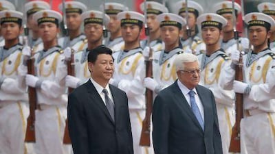 Chinese president Xi Jinping (left) accompanies Palestinian president Mahmoud Abbas to view an honour guard during a welcoming ceremony outside the Great Hall of the People in Beijing.