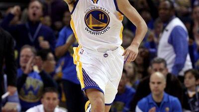 Klay Thompson of the Golden State Warriors reacts after making a basket during his 41-point night against the Los Angeles Lakers in an NBA victory for the Warriors on Saturday night. Ezra Shaw / Getty Images / AFP / November 1, 2014