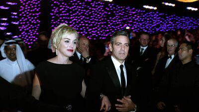 US actress Sharon Stone arrives with actor and director George Clooney at the opening of the 4th Dubai International Film Festival in 2007. AFP