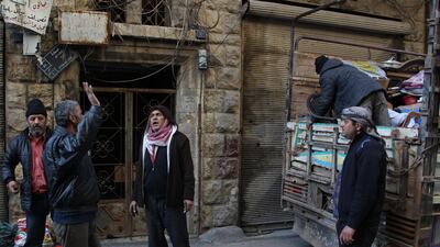 Syrians load their belongings into a truck before driving away from Maaret Al-Numan in the northwestern Idlib province. AFP