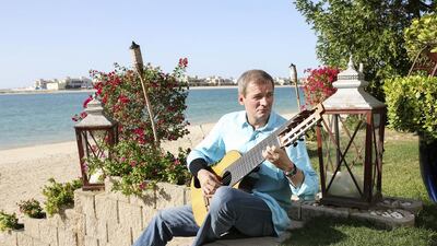 Helmut M. Schuehsler, CEO of TVM Capital, plays guitar at his Palm Jumeirah home in Dubai. Sarah Dea / The National
