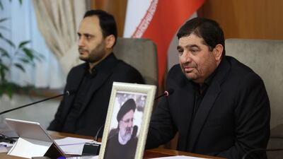 Iran's First Vice President Mohammad Mokhber, right, leads a cabinet meeting in Tehran on Monday with a photo of late President Ebrahim Raisi placed in front of the seat next to him. AFP
