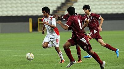 Abdullah Salem, left, of the UAE is on the run as three Qatar players give chase at Mohammed bin Zayed Stadium in Abu Dhabi.