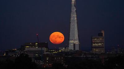 The supermoon rises behind The Shard in London. AP Photo