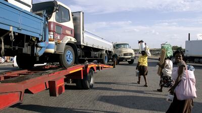 Zimbabwean women cross the street as they head towards the Beitbridge Border Post in Musina, South Africa. Themba Hadebe / AP Photo