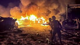 Civil defence workers battle a fire after an Israeli strike on a warehouse in Khan Younis, southern Gaza, on the second day of Eid Al Adha. Reuters