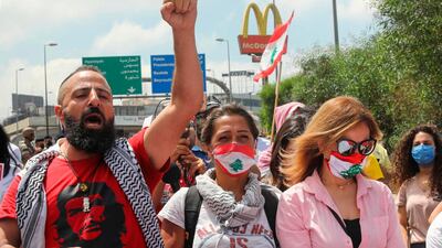 Lebanese anti-government protesters chant slogans near the presidential palace in Baabda, east of Beirut, on June 25, 2020. AFP