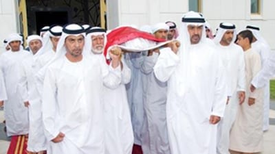 Sheikh Mohammed bin Zayed, Crown Prince of Abu Dhabi and Deputy Supreme Commander of the UAE Armed Forces, centre right, and Sheikh Hamdan bin Zayed, the Ruler's Representative in the Western Region and Chairman of the Environment Agency, centre left, carry the body of Sheikh Ahmed bin Zayed with their brothers and family.
