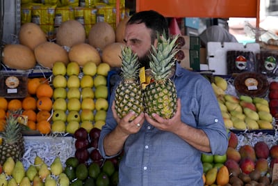 A Damascus vendor sells fruit, some of which were not available while deposed president Bashar Al Assad was in power. AFP