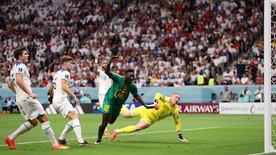 Ismaila Sarr of Senegal shoots just over the bar as Jordan Pickford of England dives. Getty