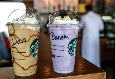 A grande or medium cup contains 55g grams of sugar - equal to five cans of Coca Cola. Victor Besa / The National