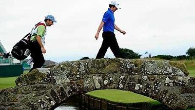 Rory McIlroy walks across the bridge on the 18th hole on his way to a round of 63 at St Andrews.