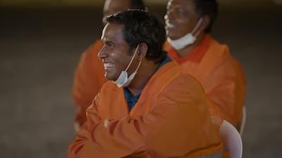 The construction workers could not hide their delight at the surprise scholarships. Courtesy, Etisalat