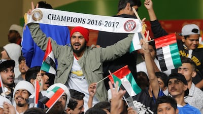 Al Jazira fan holds up a banner before the match. Reuters