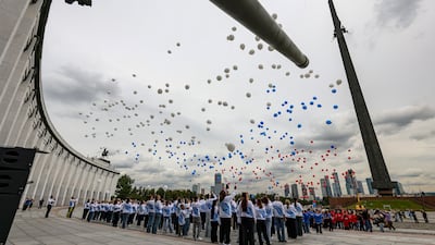 Russian cadets and volunteers release balloons bearing the national flag colours, during Flag Day celebrations at Poklonnaya Hill, in Moscow. EPA