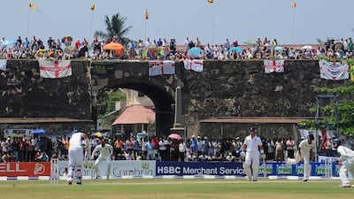 In this file photo from 2012, England fans watch from the top of the 17th century Dutch fort overlooking Galle International Stadium. Lakruwan Wanniarachchi / AFP