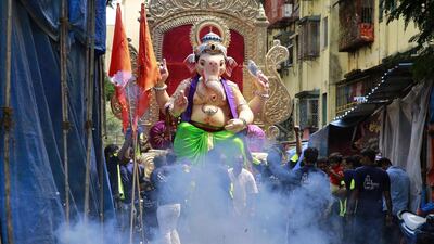 People light fireworks near a statue of the Hindu god Ganesha during the Ganesh Chaturthi festival in Mumbai, India. Rafiq Maqbool / AP Photo